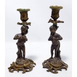 A pair of decorative bronzed and brass figural candlesticks, height 23cm.