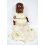 An early 20th century baby girl doll, the celluloid head with open/close glass eyes,