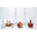 A pair of late 19th century clear glass squat globular decanters with slender faceted necks and