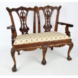 A doll sized mahogany framed Chippendale style two seater settee with upholstered seat raised on