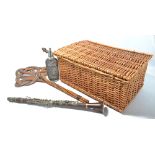 A wicker picnic basket, a carpet beater, a clear glass wirework covered syphon and a resin clarinet.