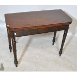 A Victorian walnut foldover tea table with baize lined recess and turned legs,