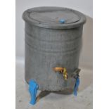 A vintage galvanized cylindrical boiler with hinged lid above polished brass and wooden handled