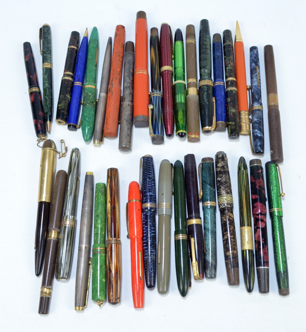 A collection of thirty-five vintage fountain pens, ballpoint pens and pencils,
