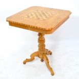 A Continental bleached walnut and inlaid games table with chess board to turned tripod base,