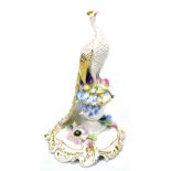 A Royal Crown Derby model of a peacock on an urn with encrusted flowers to a gilt decorated base,