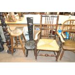 A spindle back rush seated elbow chair, an ebonised spinning chair and a stool (3).