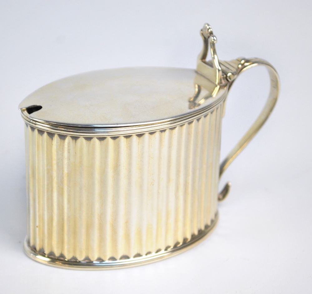 WILLIAM PLUMMER; a George III hallmarked silver oval mustard pot with fluted sides,