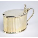 WILLIAM PLUMMER; a George III hallmarked silver oval mustard pot with fluted sides,