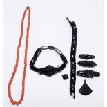 A string of graduated coral beads, length 40cm, and some jet items including bracelets,