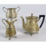 A circa 1900 Persian white metal three piece tea set comprising a circular tapering teapot,