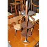 A mahogany three tiered folding cake stand and a poker work decorated three legged stool (2).