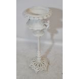 A Victorian white painted plant stand with shaped and pierced overhanging rim,