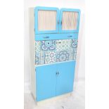 A 1960s kitchen cabinet, now blue and cream painted and with applied paper decoration, width 75cm.