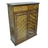 A stripped pine side cabinet with moulded rectangular top above two drawers and two cupboard doors