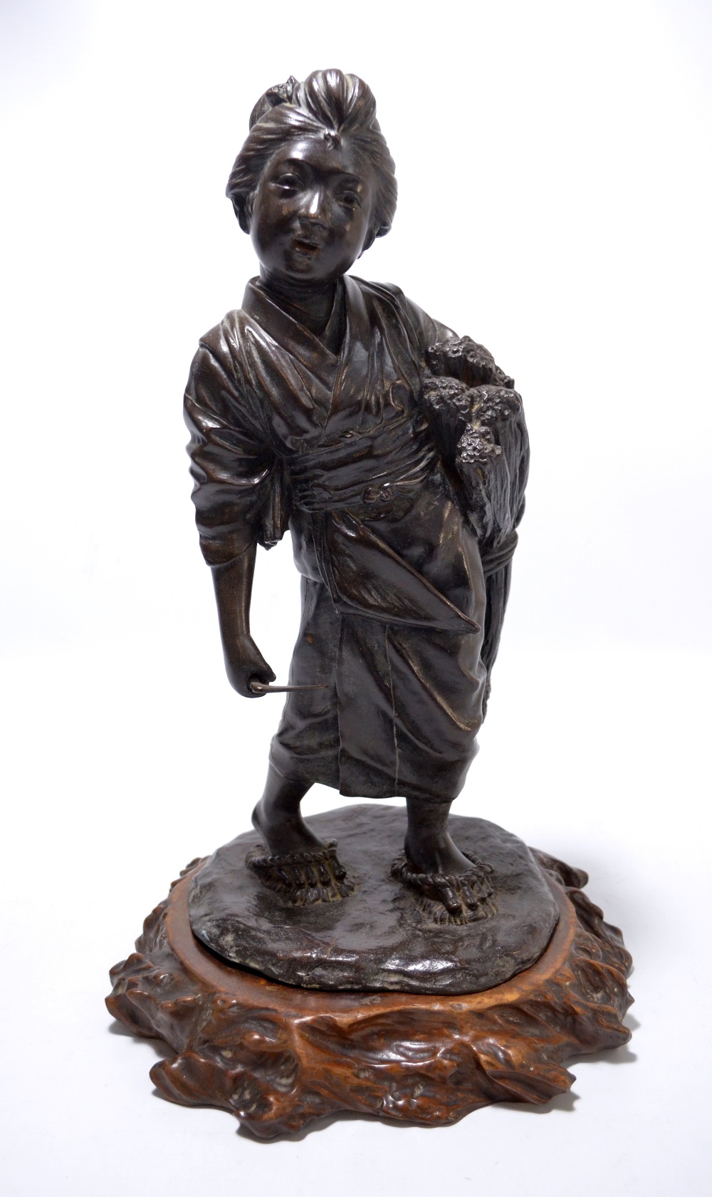 A Japanese late Meiji period bronze figure of a harvesting woman with small scythe and a sheaf of