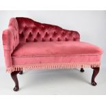 A doll or child sized pink upholstered chaise longue on cabriole legs to pad feet with fire label