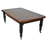 An early Victorian mahogany wind-out dining table with two extra leaves and carved turned legs to