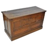 An 18th century oak blanket box, with panelled front and split hinged lid, width 138cm.