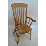 An early 20th century kitchen Windsor chair with pierced splat back on turned baluster supports.