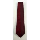 GIANNI VERSACE; a silk burgundy textured tie.