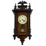 A late 19th century walnut and ebonised Vienna style wall clock of small proportions with two piece