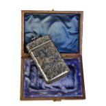 A late 19th century French silver vesta case niello decorated with hunting scene on foliate scroll