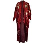 A Japanese crimson red silk kimono with detailed embroidered decoration in silver thread depicting