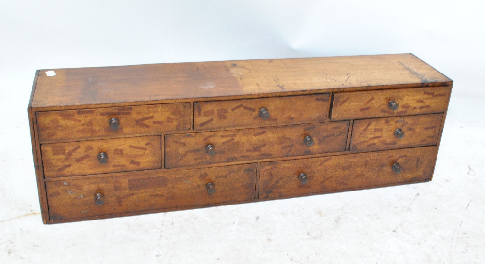 A mahogany table top cabinet assortment of eight variously sized drawers, width 85cm.