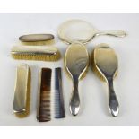 A George V hallmarked silver five piece dressing table set comprising hand mirror,