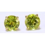 A pair of 9ct yellow gold and green peridot ear studs.