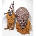 An African knitted and painted mask, length 65cm excluding fringe,