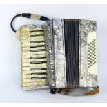 A mid-20th century Mozart accordion with two leather straps.