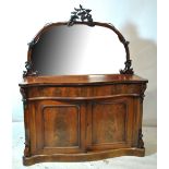 A Victorian mahogany serpentine front mirror back chiffonier with twin cupboard doors to front