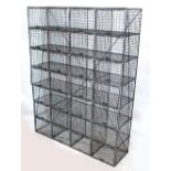 A bank of twenty-eight mesh pigeonholes,