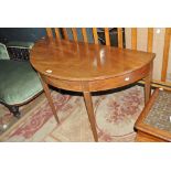 An early 19th century mahogany demi-lune side table on tapered legs to spade feet,