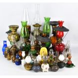 A large collection of variously sized oil lamps, to include stained glass examples,