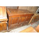 A George III oak blanket box, with hinged lid above two base drawers, width 122cm.