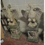 An opposing pair of composite eagle statues with outspread wings,