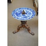 A Victorian walnut tripod occasional table with porcelain 'Old Willow' pattern circular top to