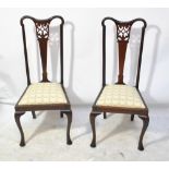 A set of four Edwardian mahogany chairs on cabriole legs.