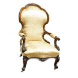 A Victorian walnut gentleman's open armchair with scrolling carved arms,