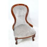 A Victorian mahogany balloon back nursing chair upholstered in grey velvet with cabriole front