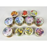 A collection of five limited edition circular ceramic music boxes decorated with humming birds