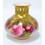 A Royal Worcester globular vase with pierced neck and flared rim,