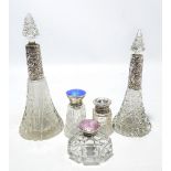 Five variously hallmarked silver mounted clear cut glass scent bottles to include a hobnail cut