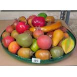 Large glass bowl full of wooden fruits
