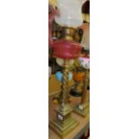 Duplex painted cranberry and brass oil lamp