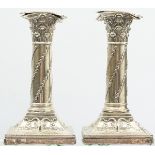 A pair of Edwardian silver candlesticks by William Hutton & Sons, London 1906, the Corinthian