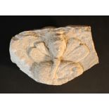 A Roman stone relief of a girl's face with wings and others; sculpted in white stone; possibly 1st-